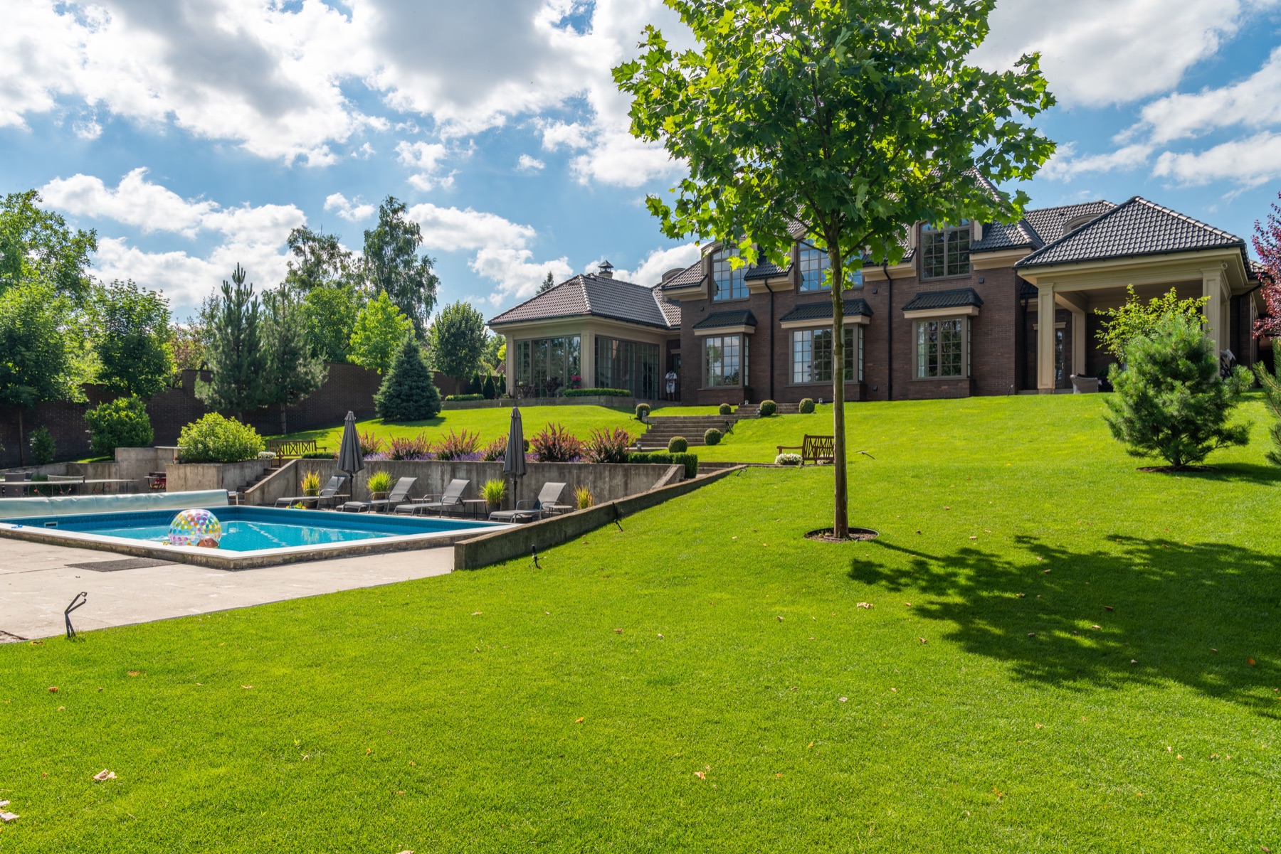 Large residential lawn with bright green grass and landscaping
